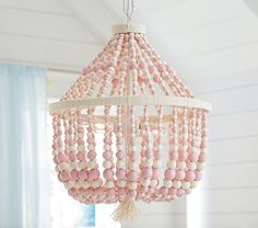 a pink beaded chandelier hanging from the ceiling in a room with white walls