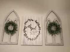 three wooden windows with wreaths hanging on them