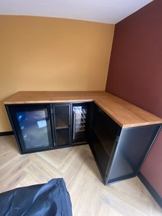 an empty room with two black cabinets in it