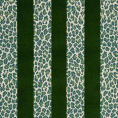 a green and white striped rug with an animal print pattern