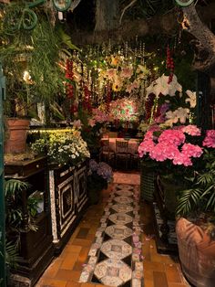 a room filled with lots of flowers and plants