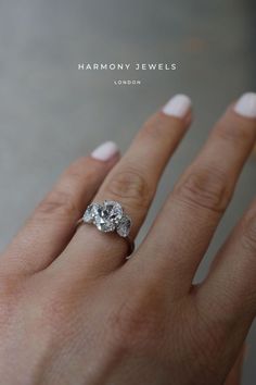 a woman's hand with a diamond ring on top of her finger and the words harmony jewels