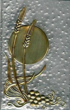 a metal plaque with wheat and grapes on it