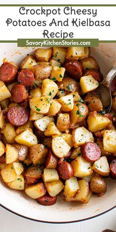 a white bowl filled with potatoes and kielbasa next to a spoon on top of a table