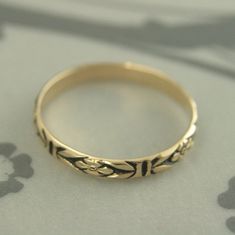 "Gold Antiqued Ring~Gold Wedding Band~Orange Blossom Ring~Romance Band~Antiqued Gold Band~Black Gold Ring~Women Gold Ring~Vintage Style Ring Introducing our new ANTIQUED Gold Bands! This solid 14K gold ring is hand crafted from preformed pattern wire. It features a lovely floral design and can be custom made in any ring size. The detail is so exquisite it looks as if it was hand engraved! Measuring 2.8mm (just under 1/8\") wide and a slim .75mm thick, it is perfect as a petite wedding ring or st Vintage Ceremonial Ring With Antique Finish, Ceremonial Vintage Ring With Antique Finish, Vintage Ceremonial Rings With Antique Finish, Vintage Adjustable Engraved Ceremonial Ring, Vintage Jewelry With Intricate Design Toe Ring, Vintage Toe Ring With Intricate Design, Vintage Flower Ring With Intricate Design For Promise, Gold Rings With Antique Finish For Wedding, Gold Wedding Ring With Antique Finish