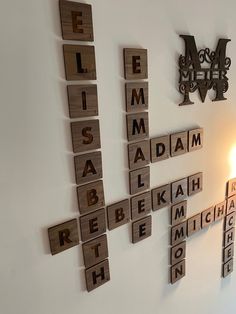 scrabble tiles are arranged on the wall to spell out names and words for each letter