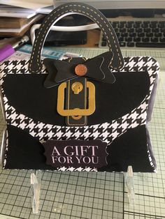 a black and white handbag sitting on top of a table