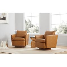 two brown chairs sitting next to each other in a living room