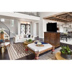 a living room filled with furniture and a spiral staircase