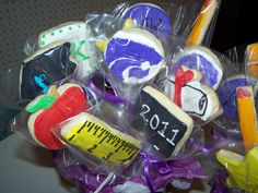 some cookies are wrapped in plastic and have writing on them as well as school supplies