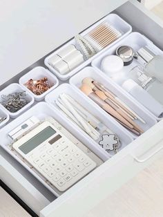 an organized drawer is shown with various items and utensils in it's drawers