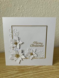 a white christmas card with flowers on it