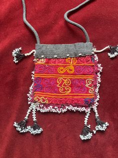 5 x 5 inch Kuchi bag  Usually made from old dress cuffs  Probably in late 70s for tourist hippie market   I think it's hand embroidered but not sure  Maybe with a hand machine ? Bohemian Hand-stitched Shoulder Bag As Gift, Bohemian Red Beaded Shoulder Bag, Red Bohemian Beaded Shoulder Bag, Traditional Hand-stitched Festival Bags, Traditional Hand-stitched Bags For Festival, Traditional Beaded Shoulder Bag For Festivals, Unique Handmade Festival Shoulder Bag, Unique Handmade Shoulder Bag For Festivals, Vintage Embroidered Shoulder Bag For Festivals