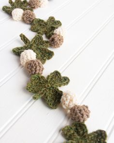 crocheted cactus garland on white background with green and brown trim, ready to decorate