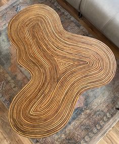 an area rug with wavy lines on the floor in front of a couch and chair