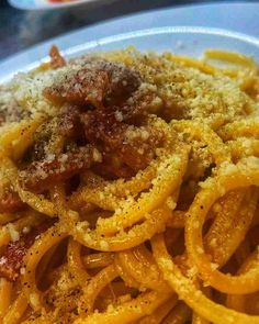 pasta with meat sauce and parmesan cheese on the top is ready to be eaten