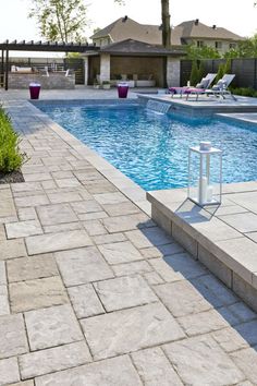 an empty swimming pool surrounded by lawn chairs