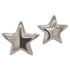 two silver star shaped studs on white background with clipping out to the side