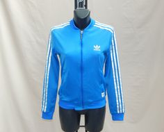 "Vintage 90s/2000s Trefoil Women's Training Tracksuit Top Jacket Authentic ADIDAS TREFOIL Sportswear . GOOD Vintage Condition . WASHED and SANITIZED Light Blue with White Stripes and Logo Please See the Pics for details. Polyamide, Polyester Label Size: 44. Women's . Please to better fit read the measurements below. Shoulder to Shoulder 15 inch / 38 cm. Shoulder to Cuff 22 inch / 56 cm. Armpit to Armpit 16.5 inch / 42 cm. CHEST 32\". Lenght 21.5 inch / 54 cm Washed and Sanitized We Post from Ita Fitted Blue Track Jacket, Blue Track Jacket For Sports In Spring, Blue Track Jacket For Spring Sports, Spring Blue Track Jacket For Sports, Blue Fitted Casual Track Jacket, Fitted Blue Track Jacket For Streetwear, 70s Vintage Fashion, Adidas Vintage, Tracksuit Tops