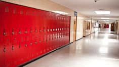 rows of red lockers in a hallway