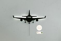 an airplane is flying through the air with its landing gear down and lights on above it