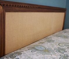 the headboard of a bed with blue walls and brown trimmings on it