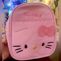 a pink hello kitty backpack sitting on top of a table