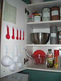 an organized pantry with lots of food and kitchen utensils on the shelves above