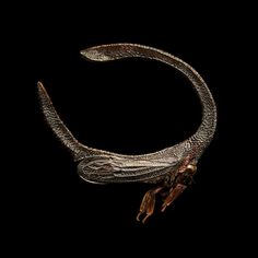 a close up of a metal object on a black background