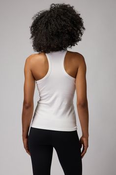 Sleek and slim. A regular to mid-length, slim fit tank with built-in shelf bra and racerback cut. Constructed in a flattering, thick-ribbed Modal Spandex blend material. | Slim Rib Tank Top in Stone Fitted Athleisure Tank Top With Built-in Bra, Fitted Tank Top With Built-in Bra For Workout, High Stretch Racerback Top With Built-in Bra, Athleisure Stretch Tank Top With Built-in Bra, Fitted Sports Camisole With Built-in Bra, Sports Tank Top With Built-in Bra And Minimal Stretch, Stretch Elastane Tank Top For Gym, Athleisure Stretch Elastane Tank Top, Elastane Racerback Tops For Yoga