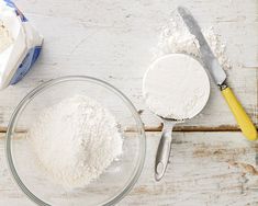 flour and butter in bowls on a white wooden table