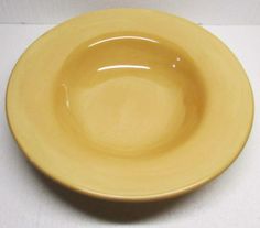 a yellow plate sitting on top of a white table