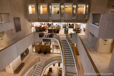 the interior of an office building with stairs leading up to two floors and multiple levels