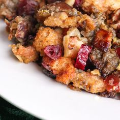 a close up of a plate of food with cranberries and nuts on it