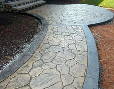 a stone walkway in front of a house