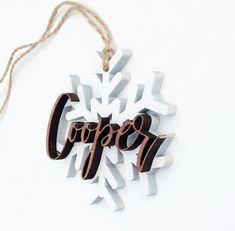 a wooden ornament with the word coffee hanging from it's side on a string