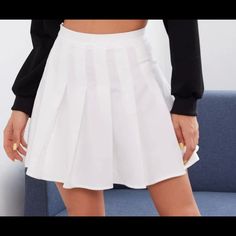 A Skater Skirt With A High-Rise Waist, Zipper On The Side, Pleated Detailing, A Mini Hem, And A Flared Silhouette. White Fitted Skort For Fall, Fitted White Skort For Fall, Trendy White Skort For Fall, Casual White Skirt For Fall, White High Waist Skirt For Fall, White Tennis Skirt For Fall, Fitted White Tennis Skirt For Fall, White Cotton Mini Skirt For Fall, White Skirt For School In Fall