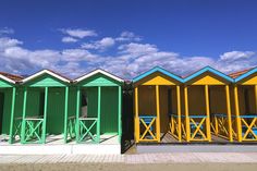 colorful beach huts with the words, versilia & apian coast beaches in tuscany