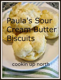 three biscuits on a plate with the words paula's sour cream butter biscuits cooking up north