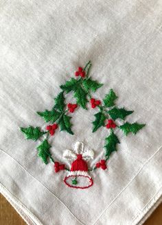 "Vintage Holly and Ringing Bell Embroidered Handkerchief. This precious handkerchief has a spray of green holly and red holly berry with a ringing bell hanging from the center. The embroidery is Christmas colorful with reds and greens. Dimensions: 12\" x 12\". The hankie is in very good vintage condition. The material is cotton voile with a rolled hem. A perfect Christmas gift for mother, daughter or aunt. A lovely way to express Christmas with a Vintage handkerchief gift. A perfect holiday host Ringing Bell, Christmas Colorful, Holiday Hostess Gifts, Embroidered Handkerchief, Hosting Holidays, Vintage Handkerchief, Embroidered Christmas, Mother Christmas Gifts, Holly Berry