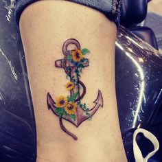 a small anchor with sunflowers on the side of it's leg,