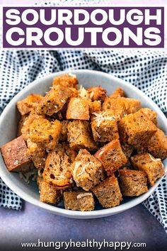 a white bowl filled with cooked tofu on top of a blue table cloth