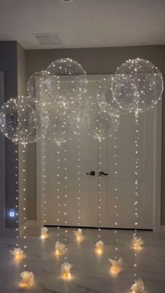 some bubbles floating in the air on top of a white floor with lights around them