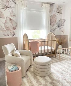 a baby's room with a crib, chair and ottoman