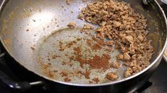 a pan filled with food sitting on top of a stove next to a frying pan