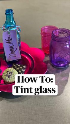 purple glass bottles and cookies on a pink plate with the words how to tint glass