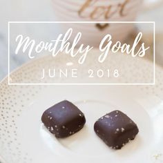 two pieces of chocolate sitting on top of a white plate with the words, month of goals