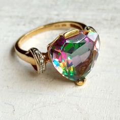 This Is A Beautiful Vintage, Levian, Solid 10k Gold Ring With A Beautifully Cut, Mystic Topaz Stone & Genuine Diamonds. The Ring Is A Size 8. The Ring Has Been Well Taken Care Of & Is In Excellent Condition. I Will Mention That It Could Definitely Use A Proper, Professional Cleaning. I Personally Don't Have Experience Or Knowledge In Jewelry Cleaning, So Rather Than Risk Damageing The Ring, I Decided To Leave It As Is & Allow Whomever Purchases It To Clean It Themselves Or Have It Cleaned Profes Levian Jewelry, Jewelry Cleaning, 10k Gold Ring, About History, Mystic Topaz, Topaz Stone, Professional Cleaning, Vintage Ring, Cleaning Jewelry