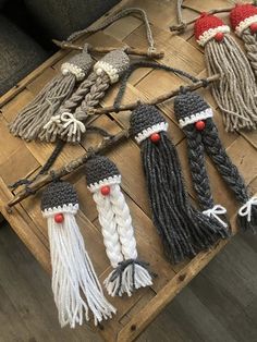 several different types of crocheted hair on a wooden table with other items in the background