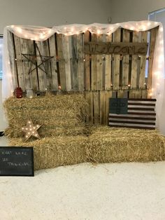 hay bales are stacked on top of each other in front of a backdrop with stars and lights